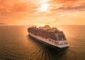 white ship on sea during sunset
