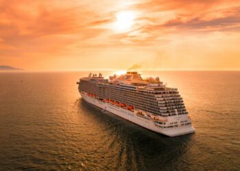 white ship on sea during sunset