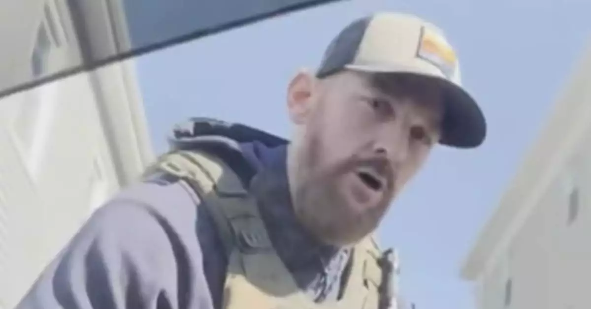 ICE agent detaining man in car