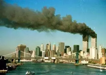 The towers of the World Trade Center pour smoke shortly after being struck by hijacked commercial aircraft, September 11