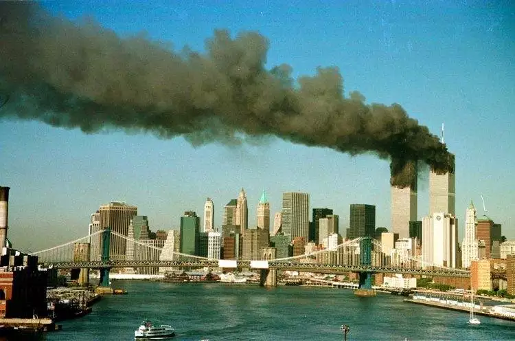 The towers of the World Trade Center pour smoke shortly after being struck by hijacked commercial aircraft, September 11