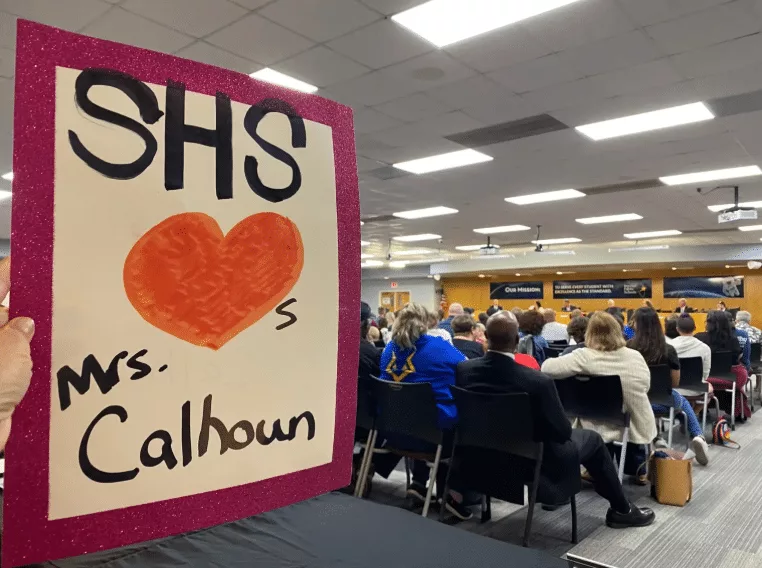 Sign supporting Melissa Calhoun at a board of education meeting