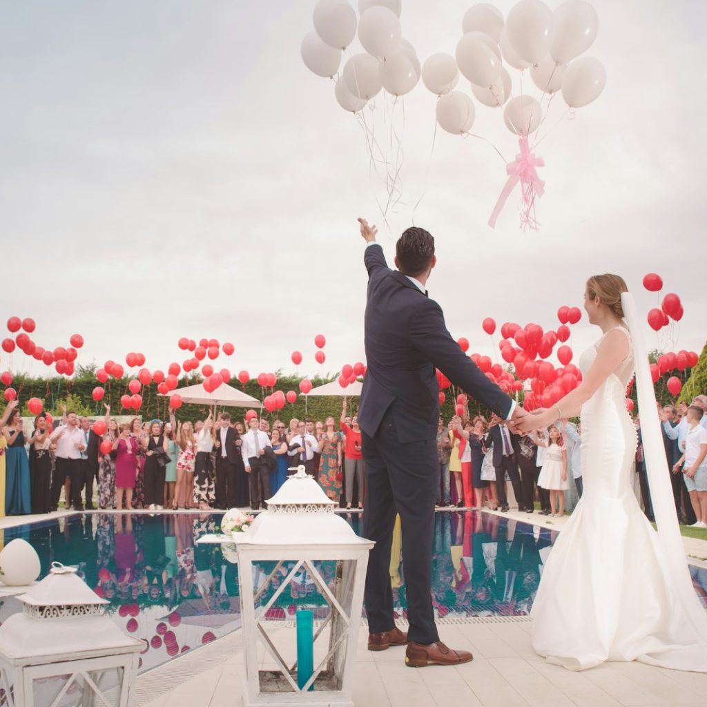 photo of a man and woman newly wedding holding a balloons