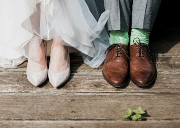 two people standing on brown wooden floor
