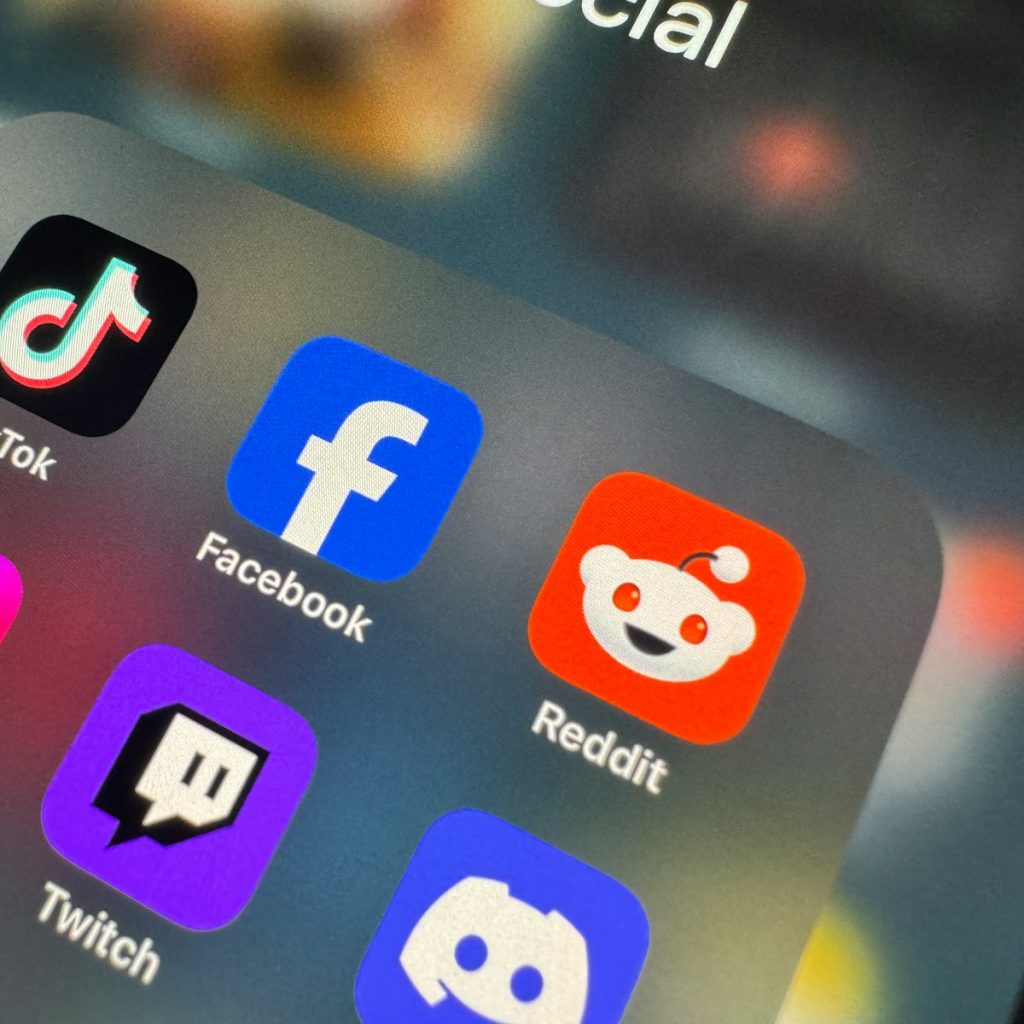 a close up of a cell phone with social icons on it