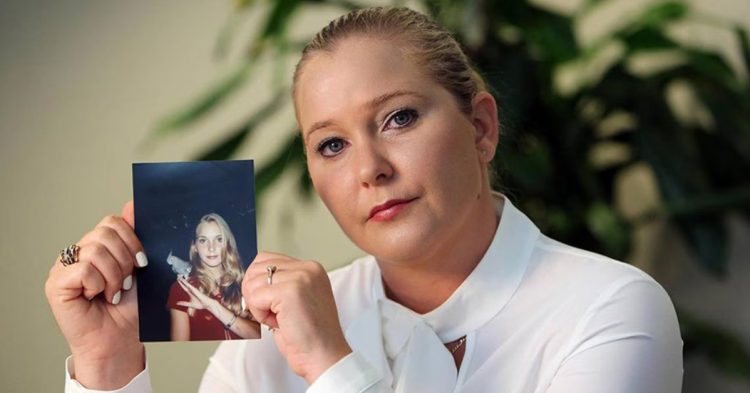 Virginia Giuffre holding a picture of herself when she was younger