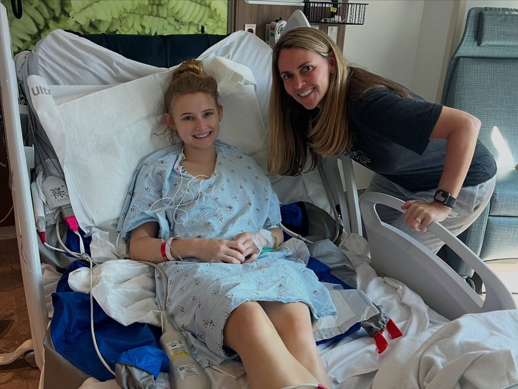 Anna Grace Phelan in hospital bed with family