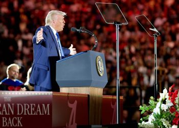 Trump at rally standing at mic
