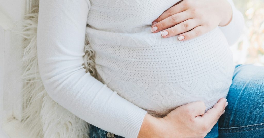 Woman holding her pregnant belly