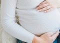 Woman holding her pregnant belly