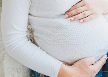 Woman holding her pregnant belly