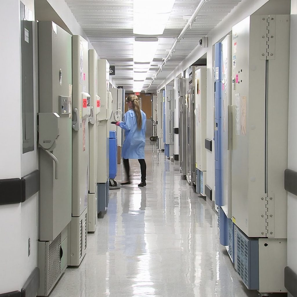 man in blue dress shirt walking on hallway