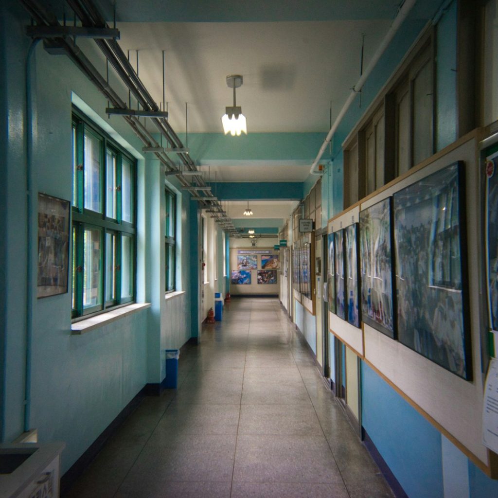 a hallway with many paintings on the walls