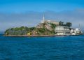 white concrete buildings and green island of Alcatraz