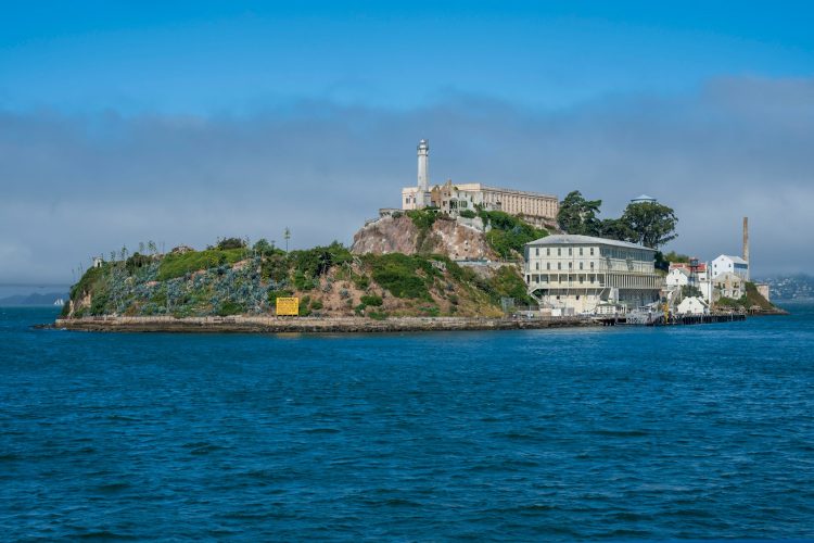 white concrete buildings and green island of Alcatraz
