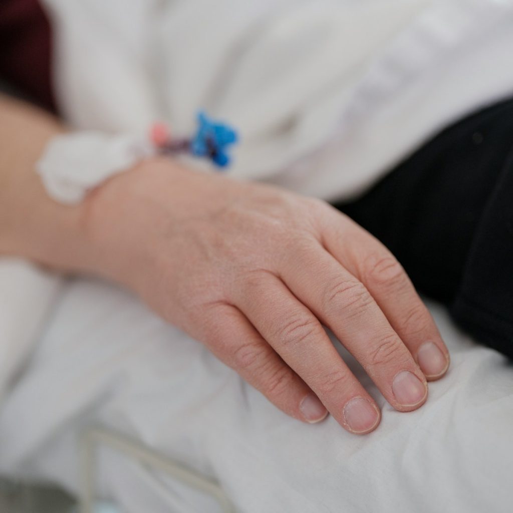 a close up of a person's hand on a bed