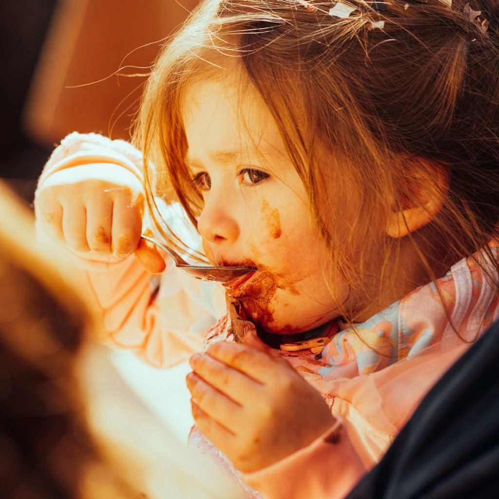 a woman eating a piece of food