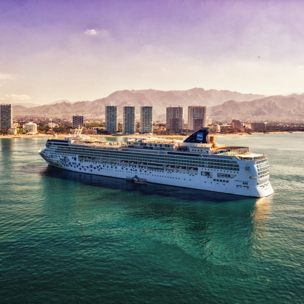 white and blue boat on body of water during daytime