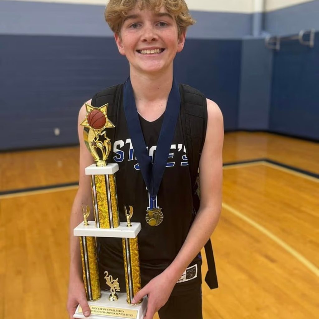 William Hand holding a basketball trophy (Facebook)