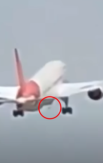 Screengrab from video of Air India crash showing grey dot under right wing