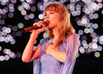 Taylor Swift on stage holding mic