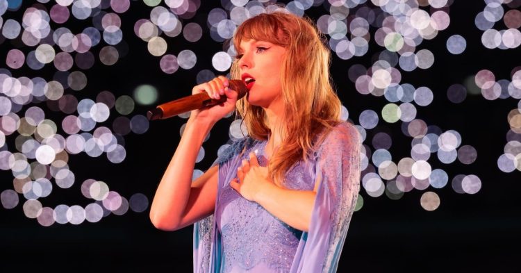 Taylor Swift on stage holding mic