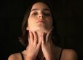 Woman holding own throat