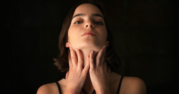 Woman holding own throat