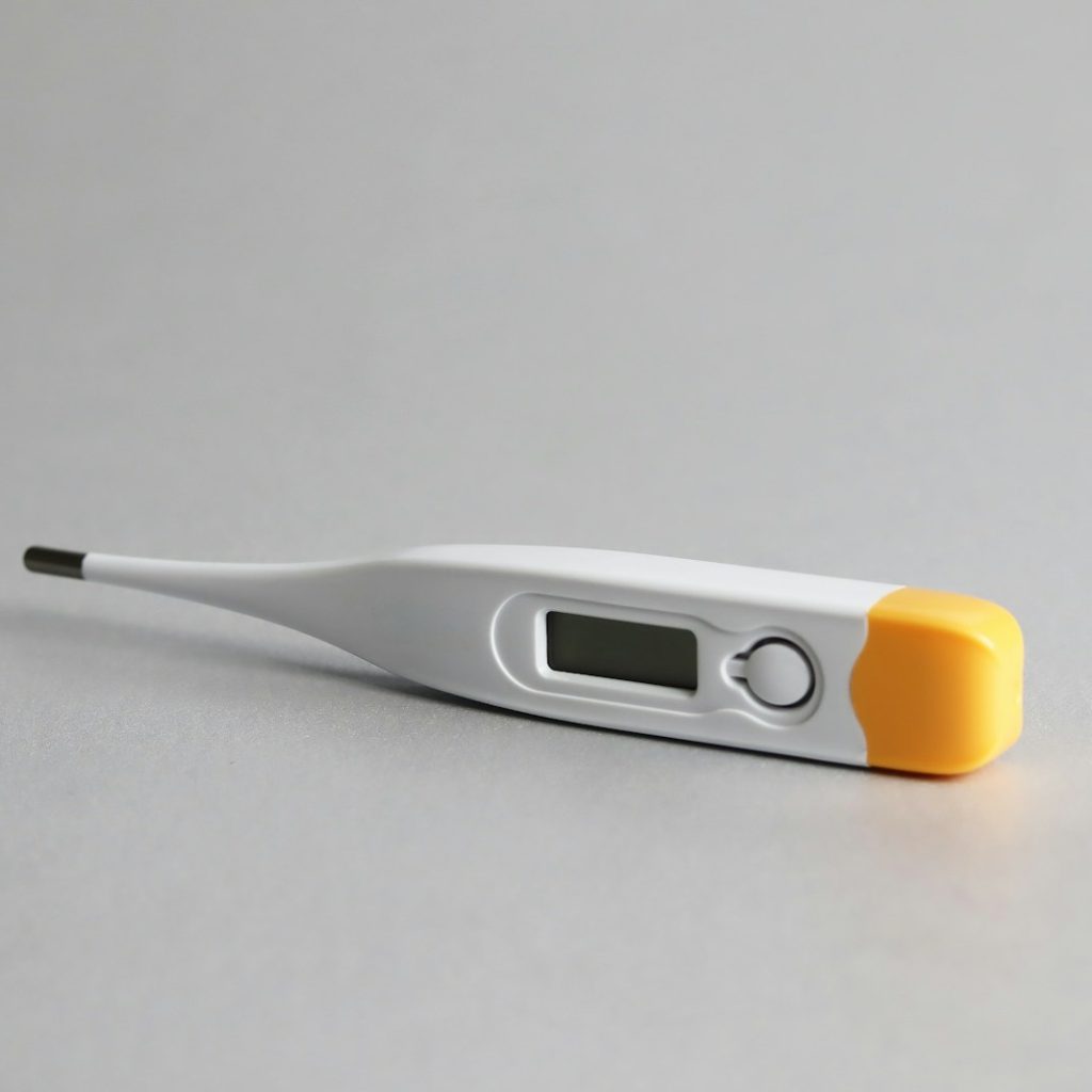 white and yellow thermometer on white surface