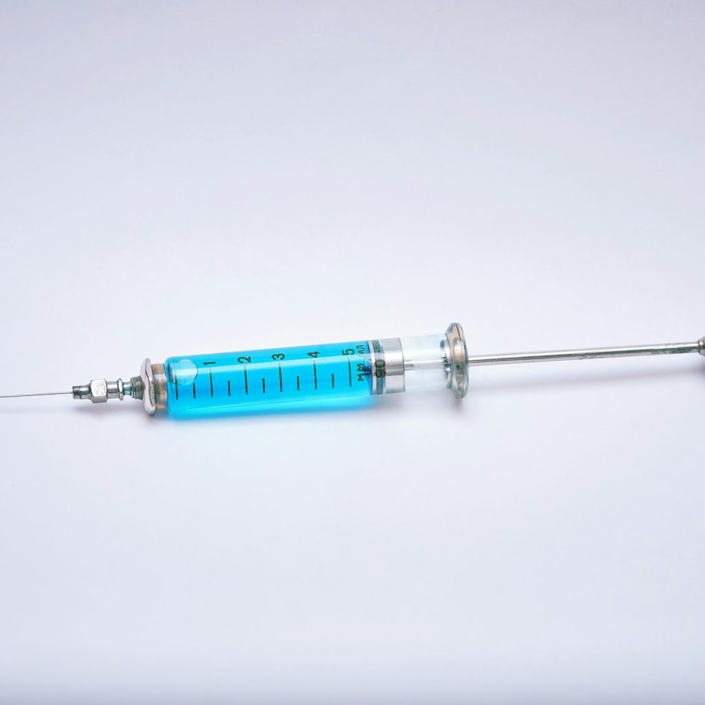 a blue and silver medical instrument on a white surface