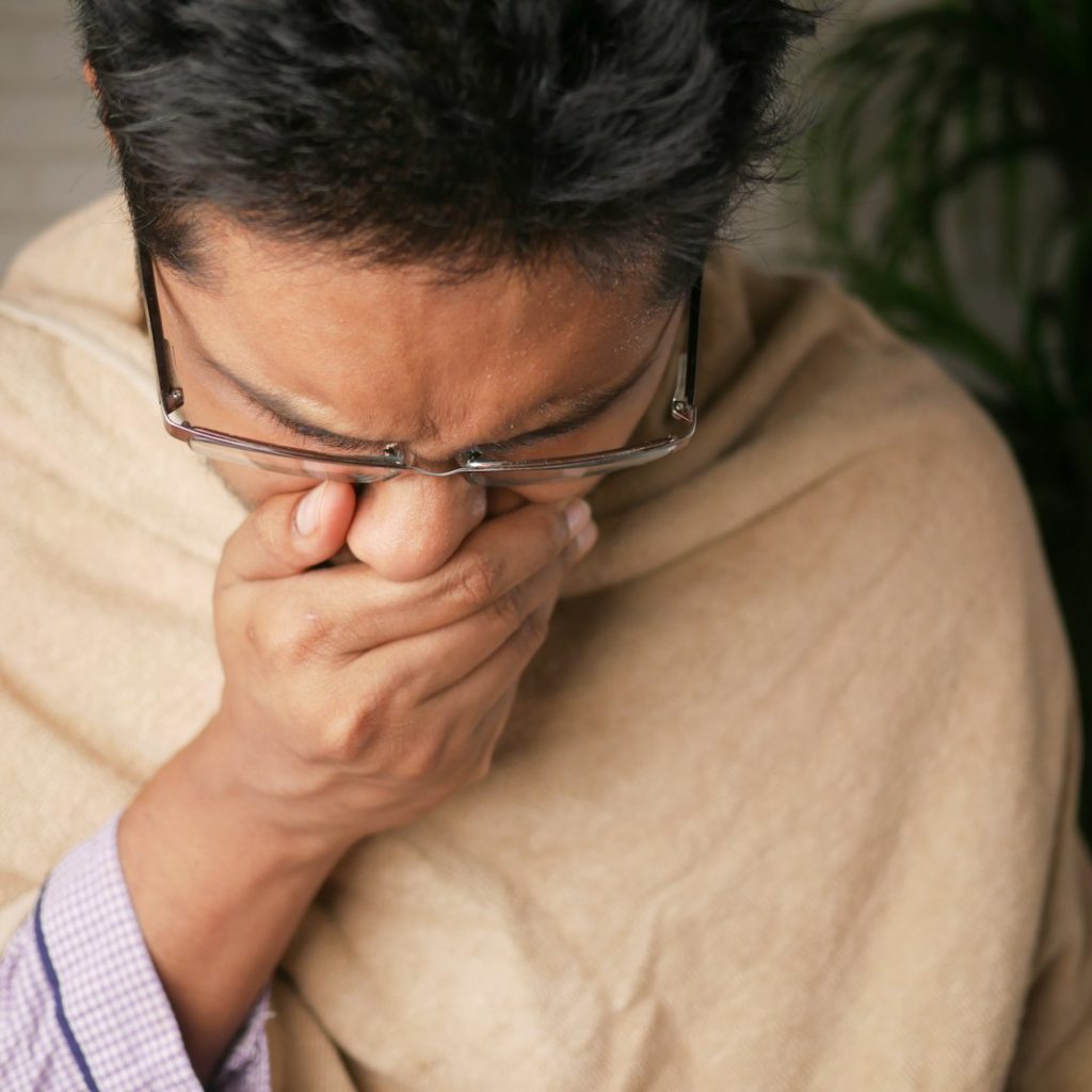 man in brown sweater wearing black framed eyeglasses