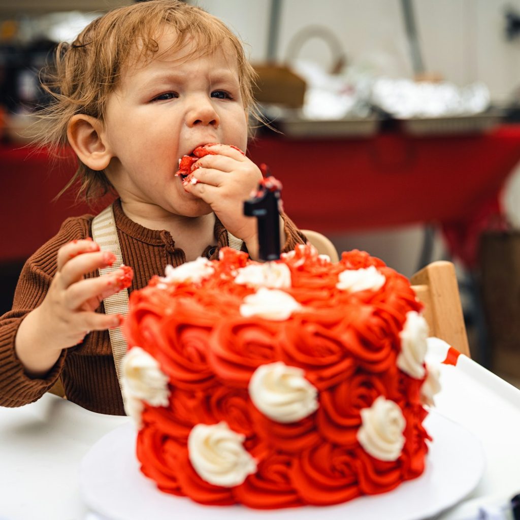 a girl eating a cake
