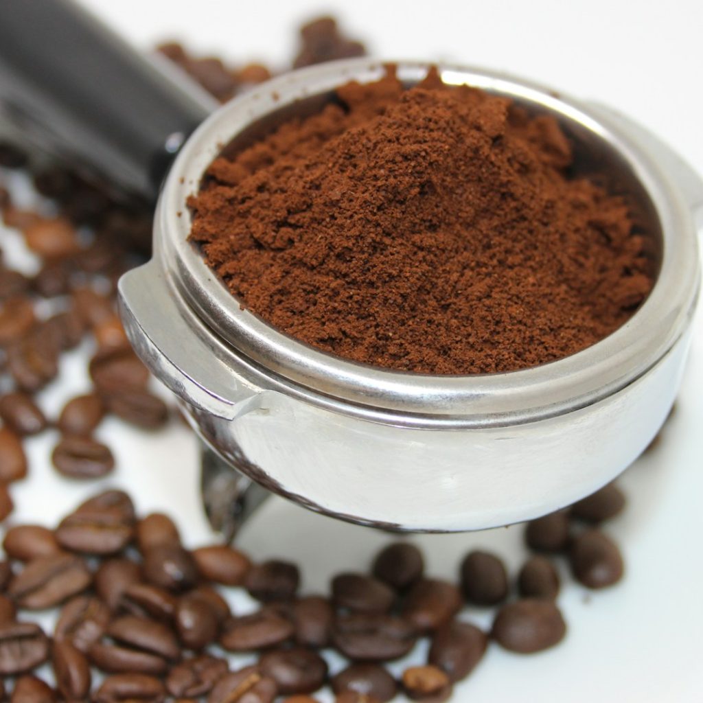 coffee beans on white ceramic mug