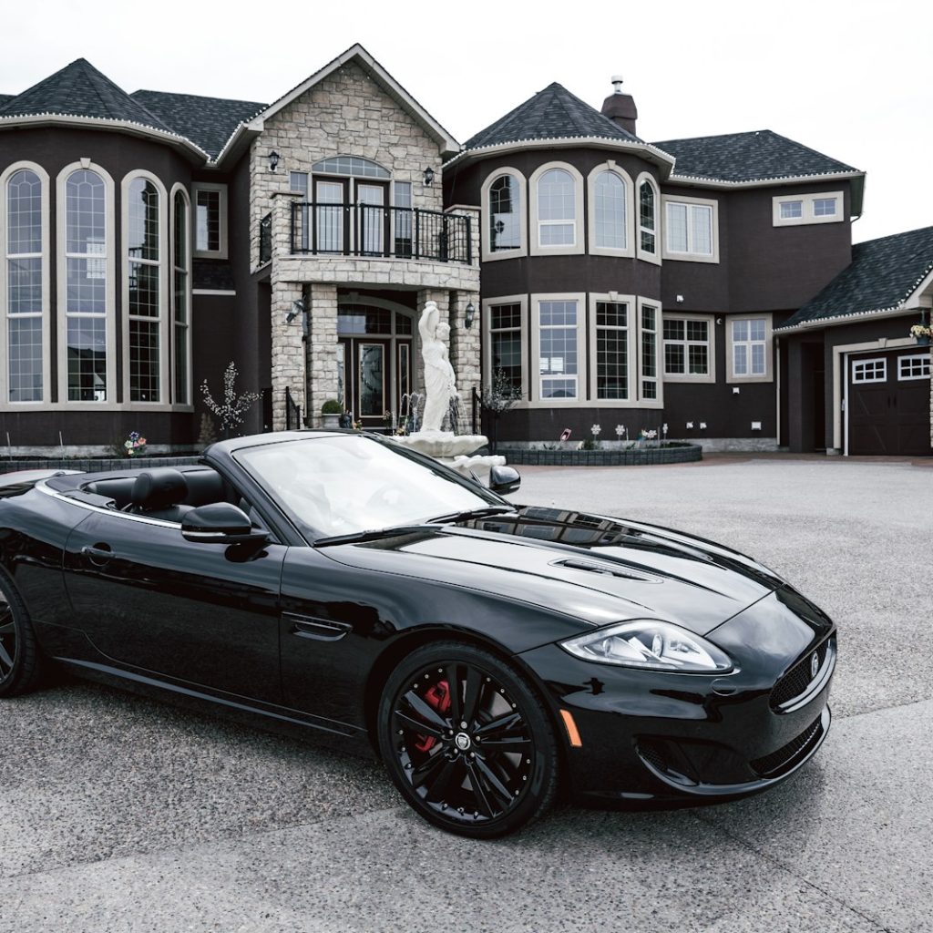 black convertible coupe parked near house