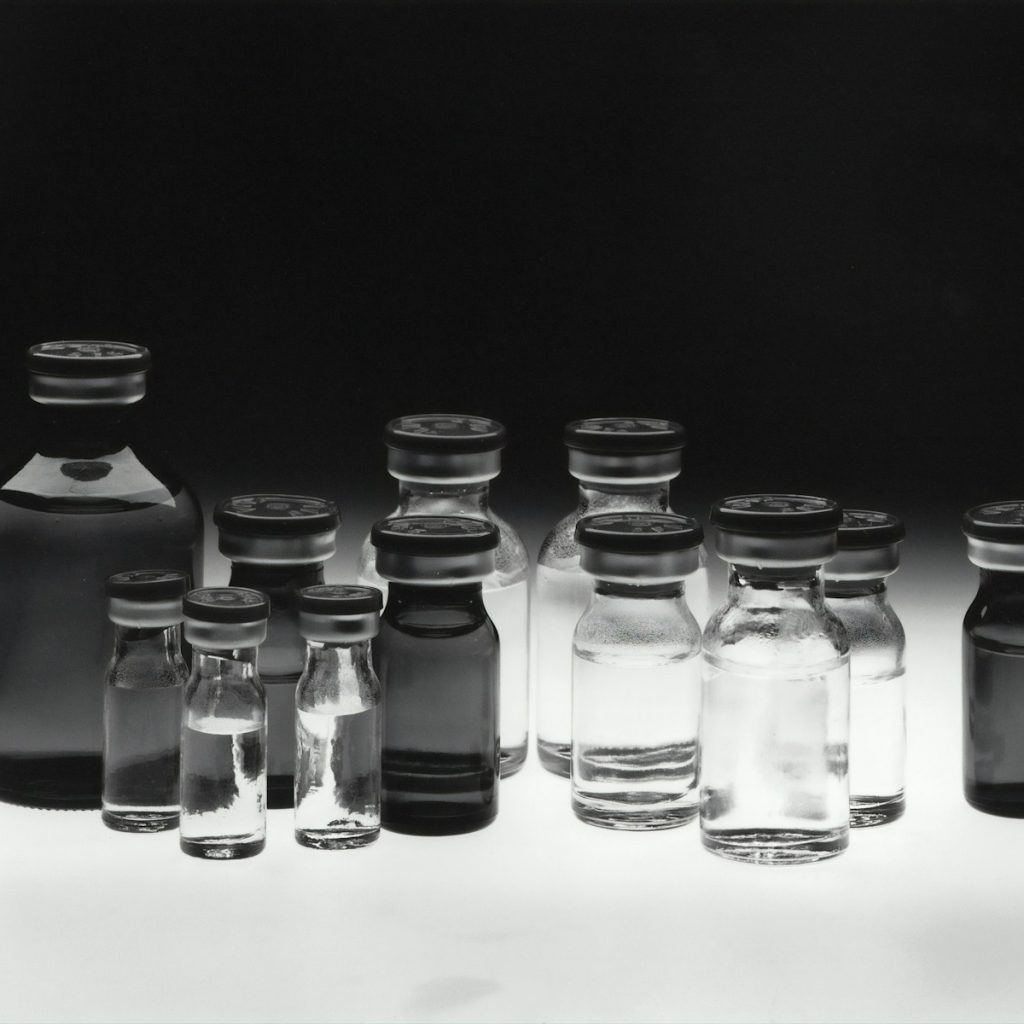 grayscale photo of glass tubes
