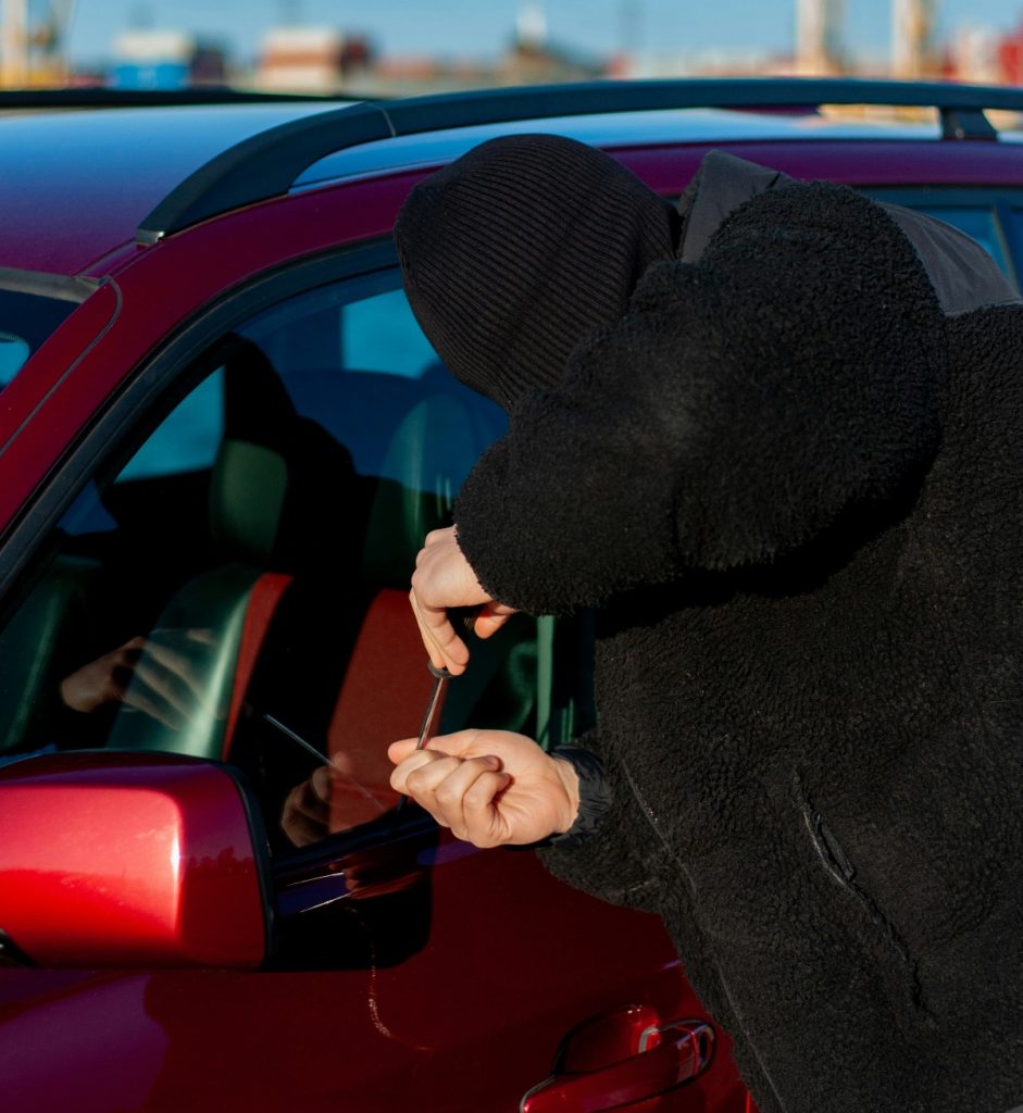 Person trying to break into car