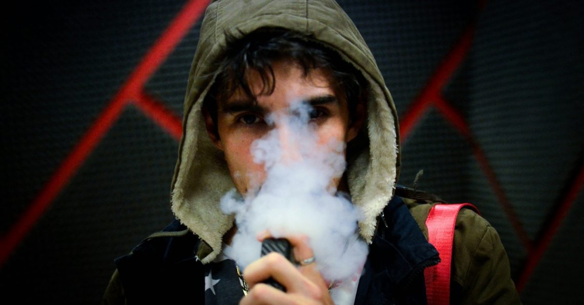 Young man vaping