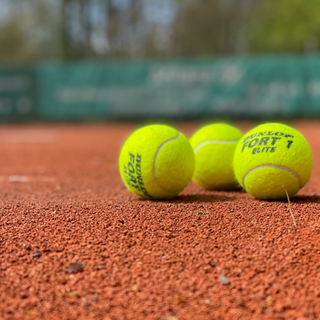 green tennis ball on brown soil