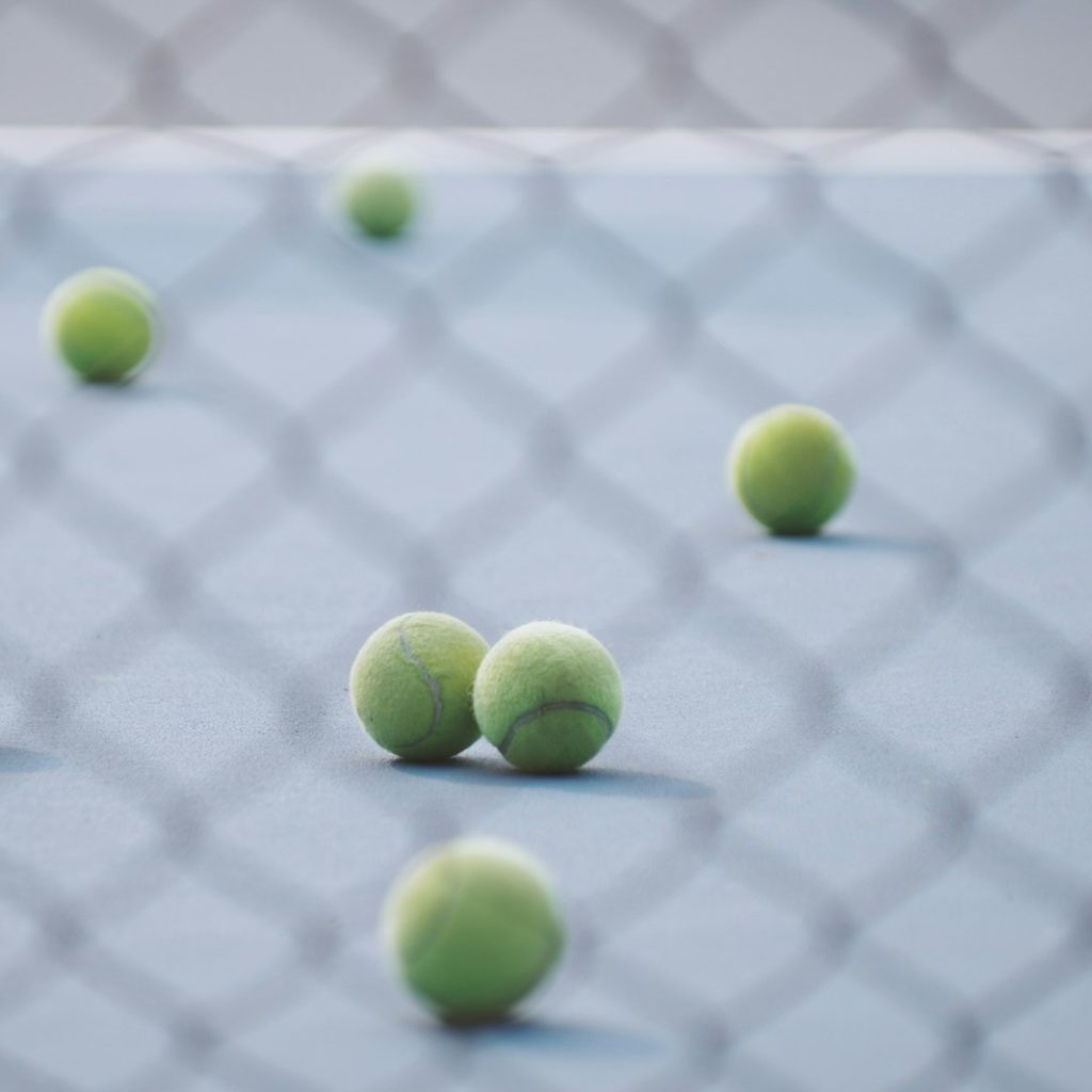 green tennis ball in court
