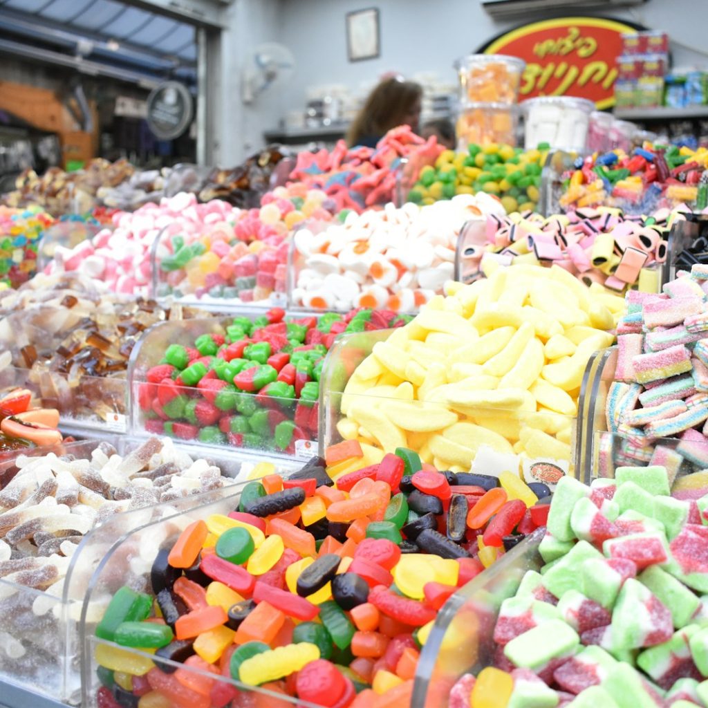 a variety of colorful candies are on display in a store